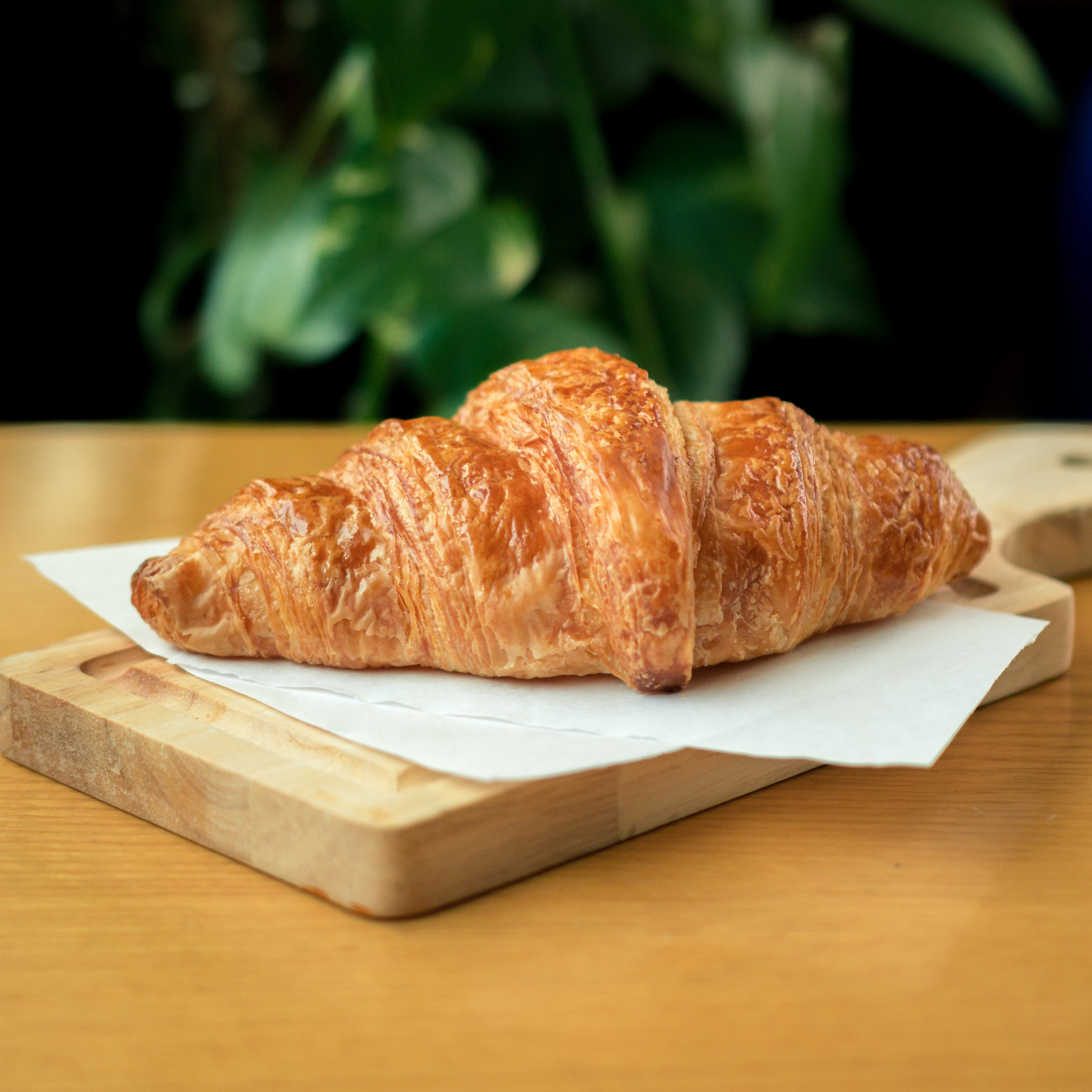 it's a croissant on a wooden plate